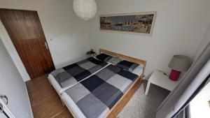 a bedroom with a bed with a checkered bedspread at Sólheimar in Blönduós