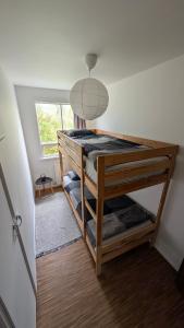 a bunk bed in a small room with a window at Sólheimar in Blönduós