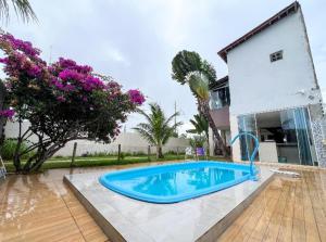 a swimming pool in front of a house at Pousada da Sami in Barra de São Miguel