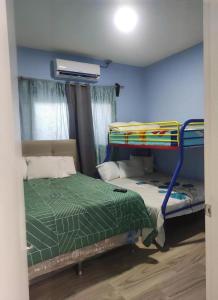 two bunk beds in a room with a blue wall at Casa villeda in La Ceiba +12 photos
