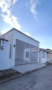 a white building with a lot of doors on it at Casa villeda in La Ceiba