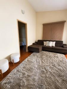a living room with a couch and a rug at Casa Spring in Alfenas
