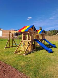 a playground with a slide in a yard at Lovely chalet in Mazamitla in Puente de las Cuevas