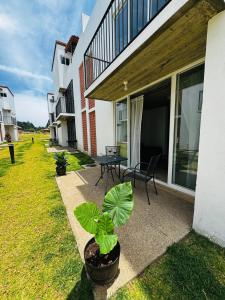 a patio of a house with a table and plants at Lovely chalet in Mazamitla in Puente de las Cuevas