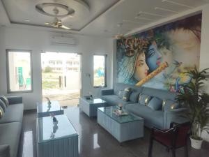 a living room with a couch and a large painting at Hotel New Imperial inn in Chhatikara