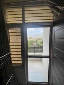 a window in a room with a view of a balcony at Hotel New Imperial inn in Chhatikara