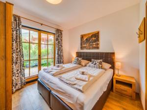 a bedroom with a large bed and a window at am Teich in Neukirchen am Großvenediger