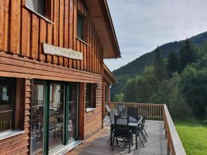 a deck with a table and chairs on the side of a house at Sjenharieja in Stadl an der Mur