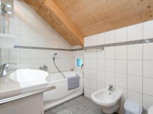a bathroom with a tub and a sink and a toilet at Baier in Stadl an der Mur +15 photos