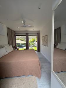 a bedroom with two beds and a large window at Fully-equipped house with pool in Grande Saline +26 photos