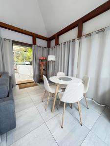 a living room with a table and chairs and a couch at Fully-equipped house with pool in Grande Saline