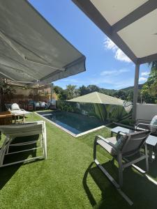 a patio with lawn chairs and a swimming pool at Fully-equipped house with pool in Grande Saline