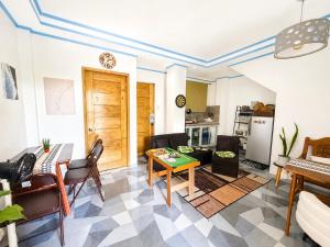 a living room with a table and a kitchen at Beachside Room with Bathroom San Juan ELYU in San Juan