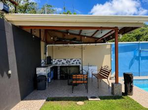 awning over a patio with a table and chairs at Ujarrás Getaway with Private Pool in Ujarrás