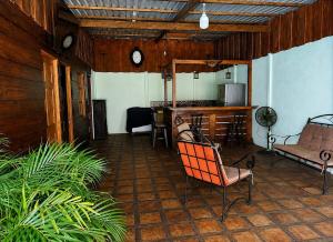 a patio with chairs and a kitchen and a counter at Ujarrás Getaway with Private Pool in Ujarrás