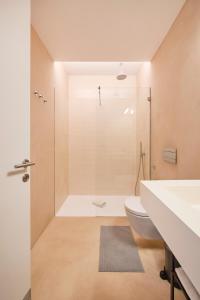 a bathroom with a shower and a toilet and a sink at Casa Portuguesa Ouro in Lisbon +49 photos