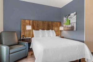 a bed and a chair in a hotel room at Extended Stay America Suites - Washington, DC - Centreville - Manassas in Centreville