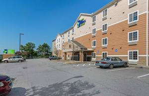 a large building with cars parked in a parking lot at Extended Stay America Select Suites - Atlanta - Chamblee in Atlanta