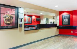 a lobby with red walls and a counter with a lion on the wall at Extended Stay America Suites - Dublin - Hacienda Dr in Dublin