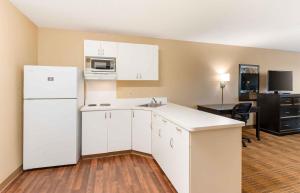 a kitchen with white cabinets and a white refrigerator at Extended Stay America Suites - Dublin - Hacienda Dr in Dublin