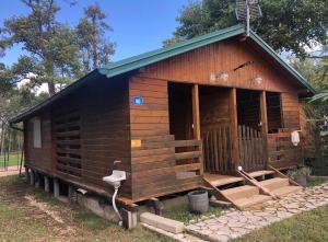a small log cabin with a large door on it at Bojana Breeze in Ulcinj