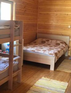 a bedroom with a bed in a wooden cabin at Bojana Breeze in Ulcinj +2 photos