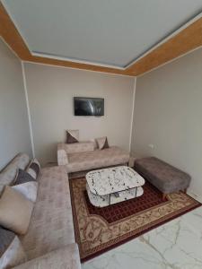 a living room with a couch and a table at Omaima villa in Taguermess +36 photos