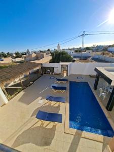 a pool on the roof of a house at Omaima villa in Taguermess