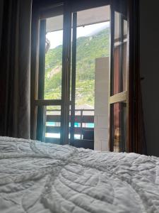 a bed in front of a window with a view at Dream Homes in Donnaz +1 photo