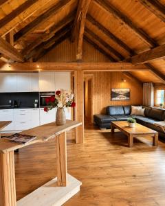 a living room with a couch and a table at Alpine Serviced Apartment with Mountain Views in Cazis