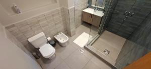 a small bathroom with a toilet and a shower at Casa Prado in San Fernando del Valle de Catamarca +15 photos