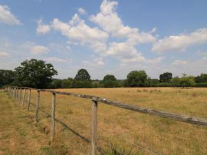 a fence in the middle of a field at The Cider Press, Motcombe, Shaftesbury in Motcombe