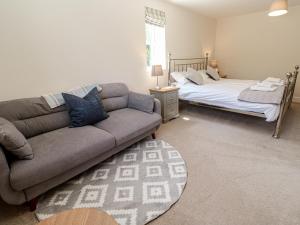 a living room with a couch and a bed at Ilgram in Newquay