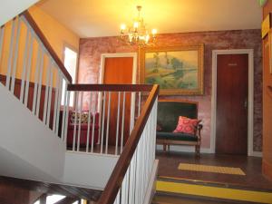 a hallway with a staircase and a living room at Hotel Victor Hugo in Dijon