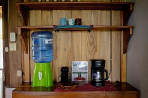 a kitchen counter with a coffee maker and a blender at Cabinas Jenny Cahuita in Cahuita +44 photos
