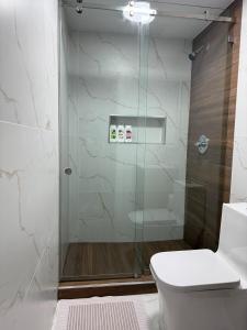 a bathroom with a glass shower with a toilet at Private Suite with Laundry in Sunset +20 photos