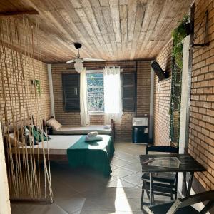 a room with a bed and a table and a window at Flats na praia de Trindade Paraty flats nazar in Paraty +21 photos