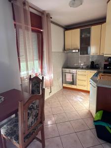 a kitchen with a table and two chairs and a table at Kuća za odmor MEDUNIĆ in Gospić
