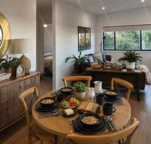 a wooden table with food on it in a living room at Guest favourite Ocean Views Breakfast Included in Charlestown