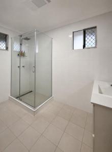 a bathroom with a glass shower and a sink at 'The Station House' Mount Isa in Mount Isa