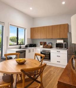 a kitchen with a wooden table and a dining room at Guest favourite Ocean Views Breakfast Included in Charlestown +17 photos