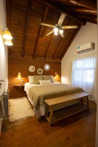 a bedroom with a large bed and a ceiling fan at Cabañas Murmullo de Agua in Mar de las Pampas +19 photos