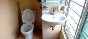 a bathroom with a toilet and a sink at GuInn in Hanoi