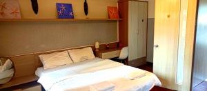 a bedroom with a white bed in a room at GuInn in Hanoi