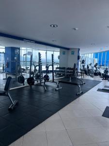 a gym with cardio equipment in a building at Beach apartment on the seashore in Las Lajas