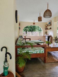 a bedroom with a bed and a table with a plant at Payapa garden Nagtabon Beach in Puerto Princesa City