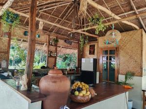 a kitchen with a counter with a bowl of fruit at Payapa garden Nagtabon Beach in Puerto Princesa City