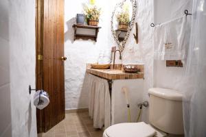 a bathroom with a toilet and a sink at Hotel Boutique Macaregua Girón in Girón +37 photos