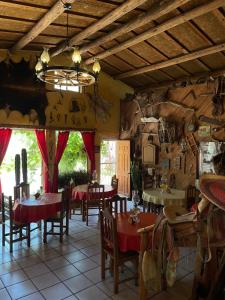 a restaurant with tables and chairs in a room at Hotel Paraiso del Oso in Cerocahui