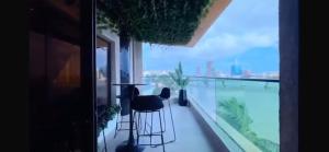 a balcony with a table and chairs and a view of the city at Orange Place - Benson Close in Lagos